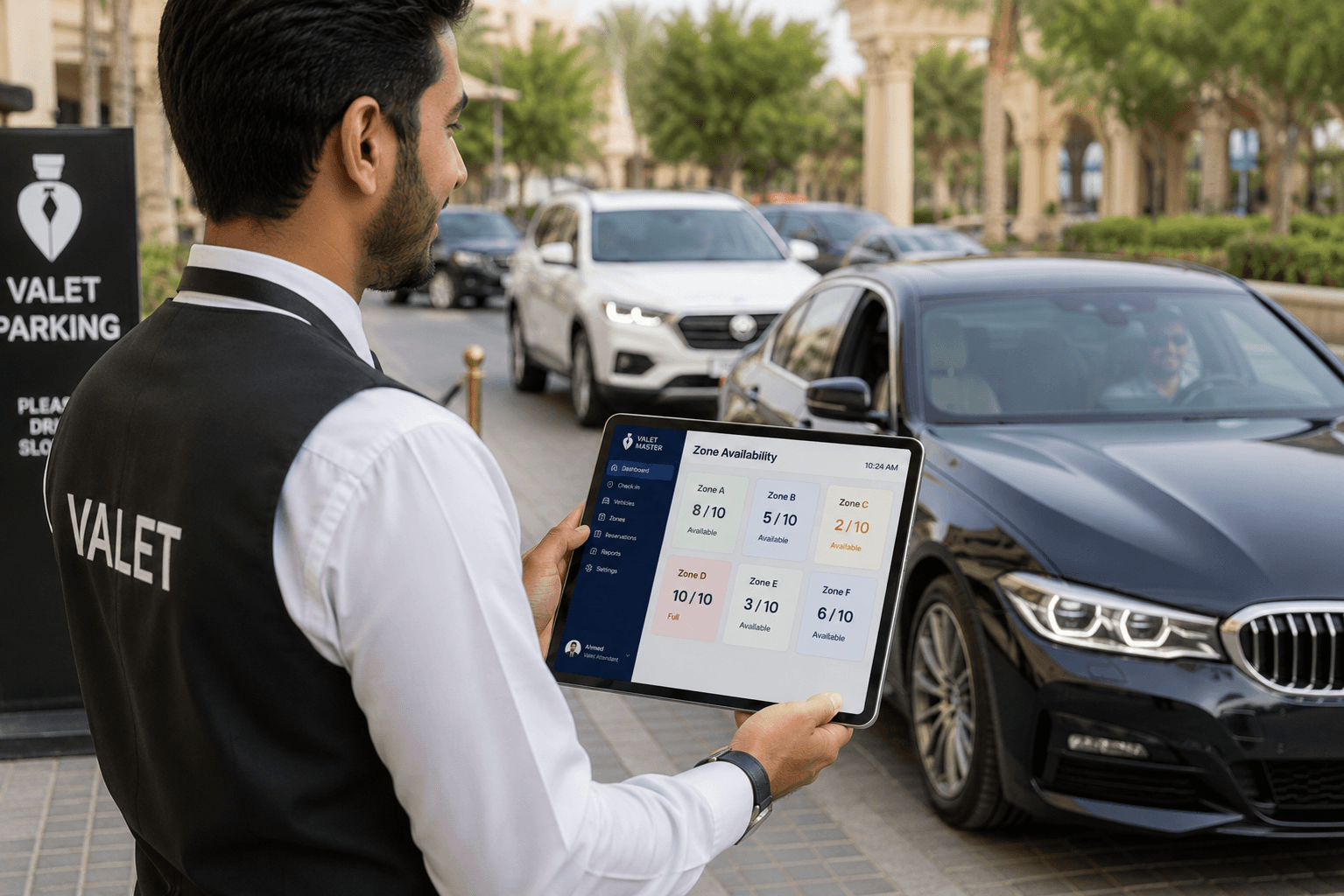 valet attendant checking parking zone availability on tablet